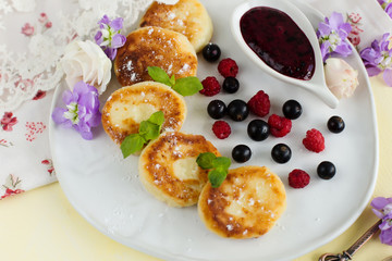 Breakfast of pancakes with jam from berries (close-up)
