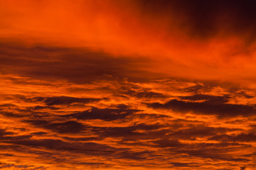 Fototapeta premium Red voluminous clouds at sunrise
