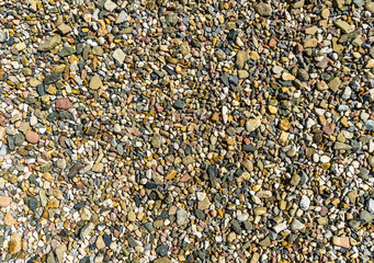 Coloured gravel and sand as a texture and background, in the abstract and many-sided 