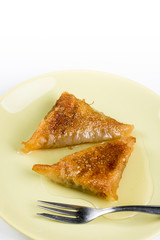 Slices of baklava pie with walnuts served on the plate