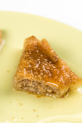 Delicous sweet tasty baklava with walnuts served on the plate closeup macro
