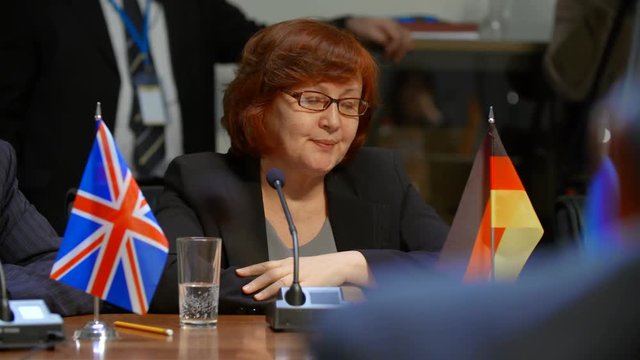 The representative of Germany yawns at the boring international meeting