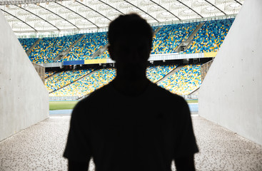 Silhouette of a man walking throught the entrance