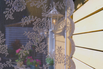 Tulle on the window of a summer house