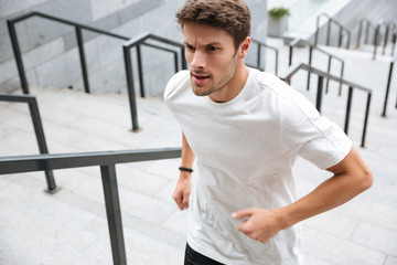 Close up of a healthy male runner in sport clothes