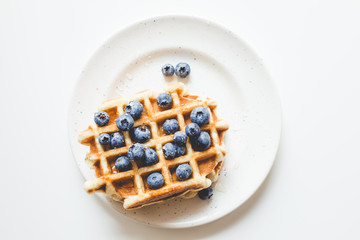 top view of stacked fresh waffles with blueberries