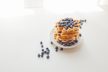 plate of fresh crunchy waffles with blueberries