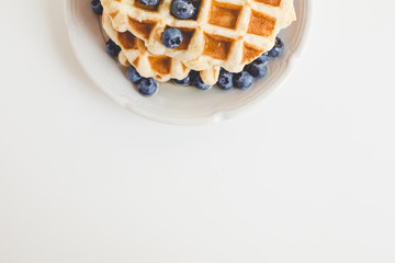 top view of tasty fresh waffles with blueberries with copy space