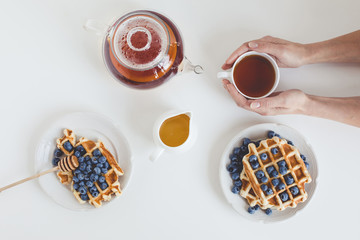 top view of delicious breakfast of tasty waffles and tea