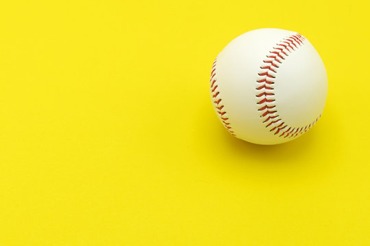 Isolated baseball on a yellow background and red stitching baseball. copy space.