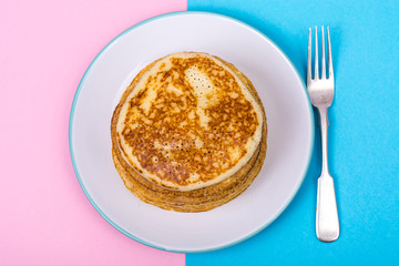 Pancakes on bright pastel color