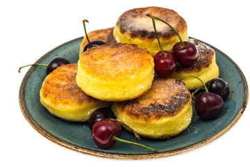 Sweet cottage cheese pancakes with powdered sugar on plate on wh