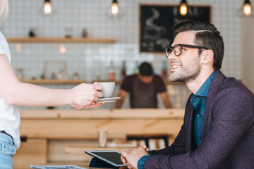 Fototapeta premium waitress with order for businessman in cafe