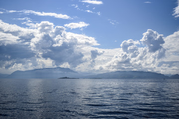 Beautiful landscape on the north sea in norway with clouds on a sunny day