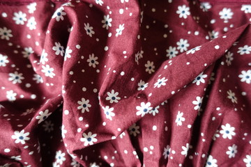 Crumpled  carmine linen fabric with white floral print