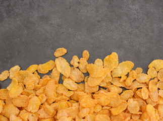 Corn flakes breakfast cereal line on a grey slate