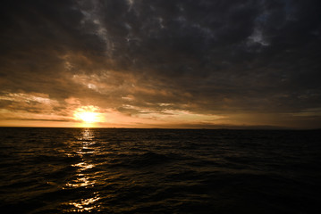Beautiful colorful sunset with clouds on the north sea, summer