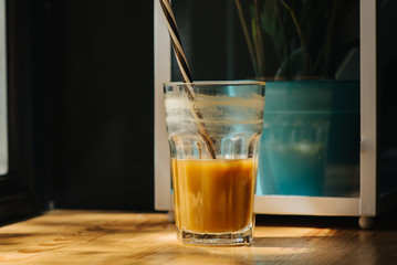 Glass of citrus coffee on the desk. Gym cocktail.
