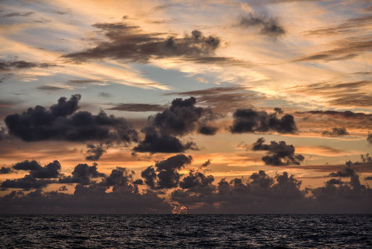 Beautiful colorful sunset with clouds on the north sea, summer
