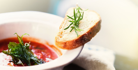 Italian Tomato soup in bowl with slice of bruschetta