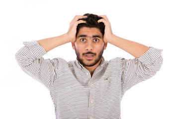 Surprised beard young man holding his head, guy wearing gray shirt and jeans, isolated on white background