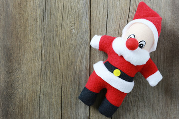 Santa Claus doll on wooden background.