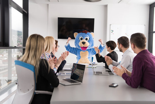 boss dresed as bear having fun with business people in trendy office