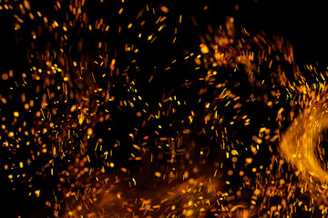 Flame of fire with sparks on a black background