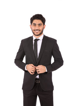 Happy handsome young businessman smiling and holding a buttun, guy wearing black suit and black tie, isolated on white background