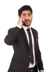 Fototapeta premium Happy handsome young businessman smiling and making a call, guy wearing black suit and black tie, isolated on white background