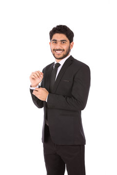 Happy handsome young businessman smiling and holding a buttun, guy wearing black suit and black tie, isolated on white background