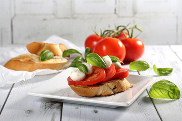 Toasted bread and tomato, mozzarella cheese, basil bruschetta 