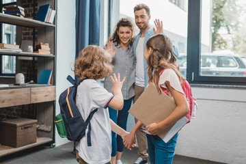 kids going to school and waving to parents