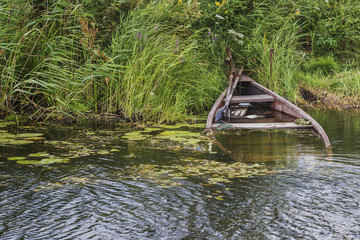 on the winding river stands several boats