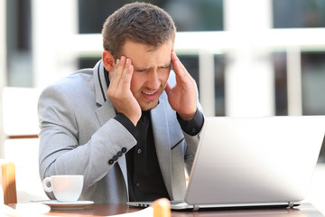 Executive suffering head ache in a coffee shop