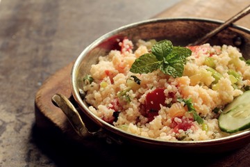 Tabbouleh Salad - Popular vegetarian Mediterranean dish made of fresh cucumber,tomatoes,parsley and coucous