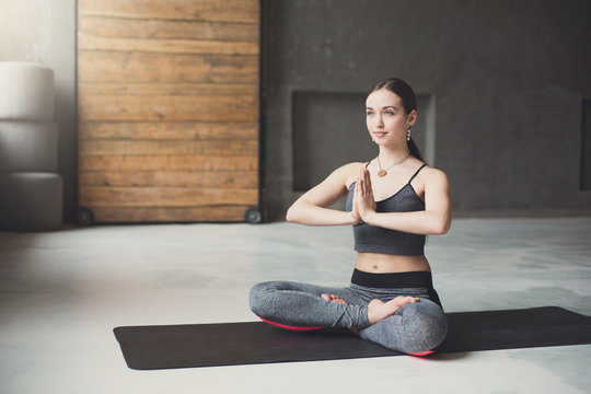 Young attractive woman practicing yoga sitting