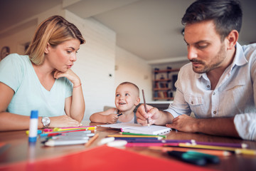 Fototapeta premium Young parent drawing with their little son