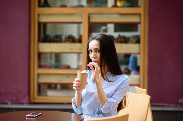 Beautiful girl coffee drinkers on the street.