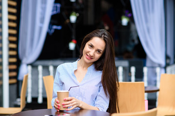 Beautiful girl coffee drinkers on the street.