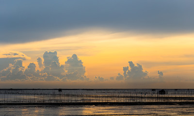 Vacation time, sunset in the sea with beautiful cloud sky.
