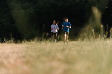 Couple running together on a field