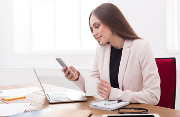 Young business woman working on phone