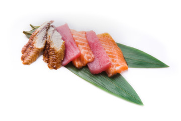 Sashimi set on bamboo leaf isolated at white