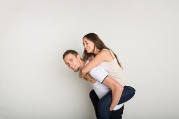 Loving couple, man piggybacking girlfriend