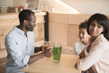 adorable african-american family in cafe