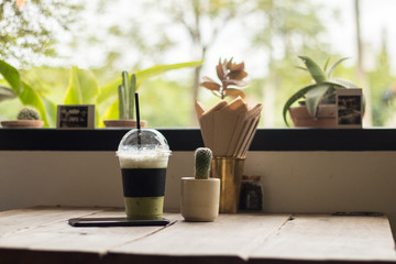 Mobile and ice green tea on vintage table, copy space
