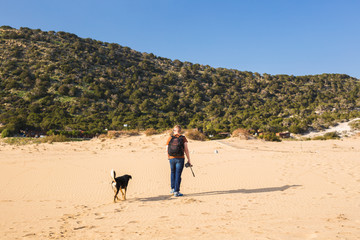 Fototapeta na wymiar Outdoors lifestyle image of travelling man with cute dog. Tourism and pet concept.