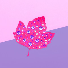 Art gallery. Autumn colored leaf in rhinestones Candy colors