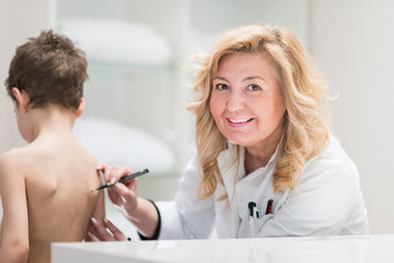 Fototapeta premium Physical therapist examining posture of a little boy